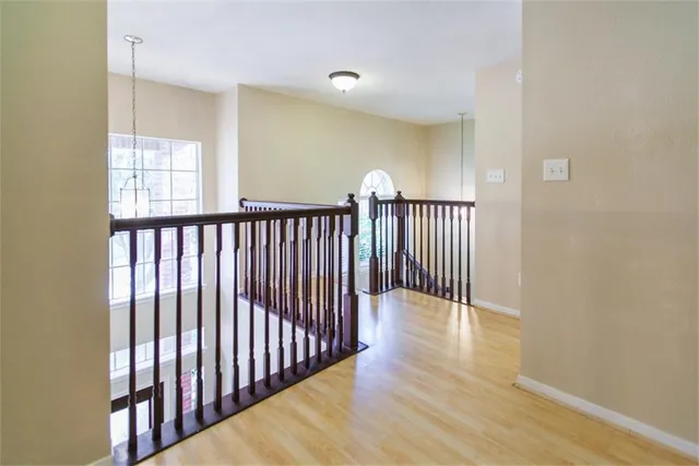 a view of hallway with wooden floor