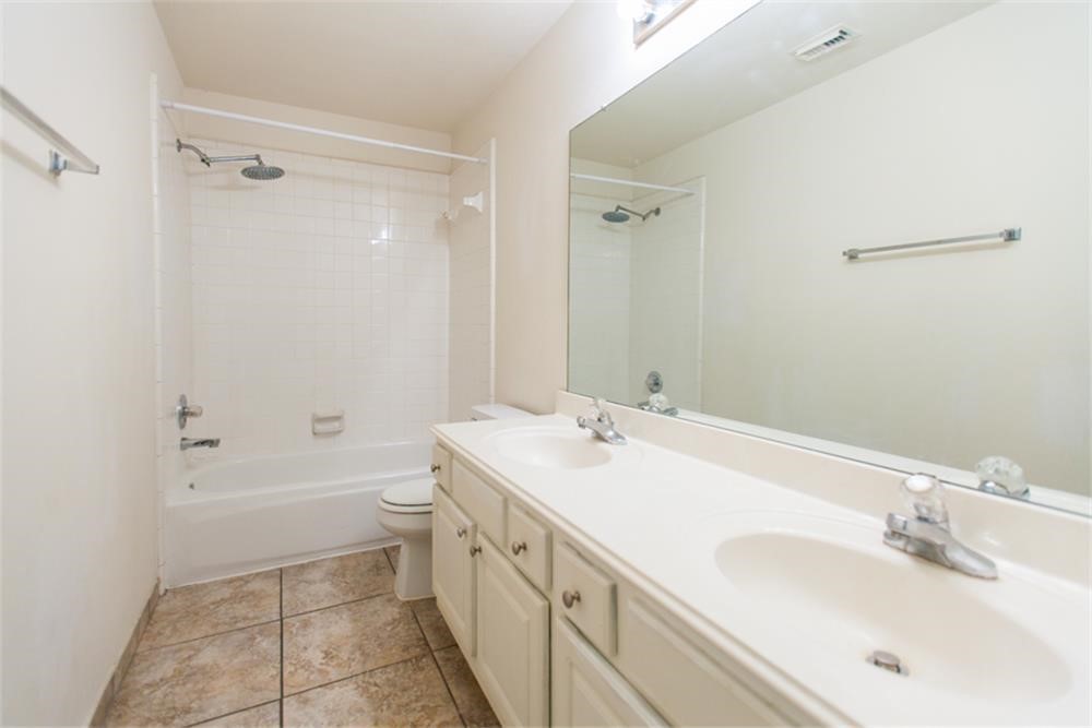 13630 Country Green Court Houston, TX 77059 - Photo 20 of 30 a bathroom with a sink a toilet and shower
