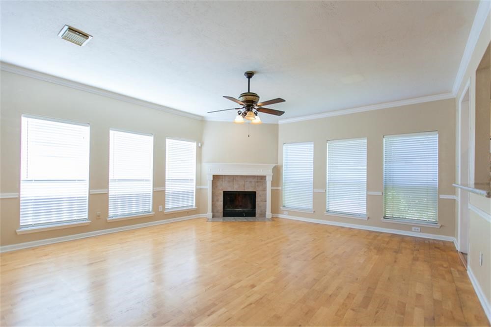 13630 Country Green Court Houston, TX 77059 - Photo 6 of 30 a view of an empty room with a fireplace and a window