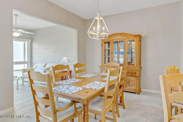 a view of a dining room with furniture and a chandelier