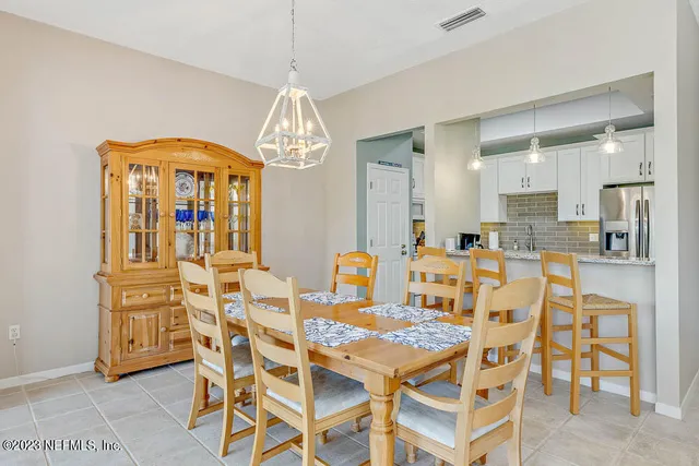 a view of a dining room with furniture and chandelier