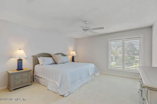 a bedroom with a bed and a lamp with window