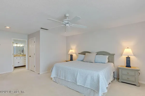 a bedroom with a bed and a lamp
