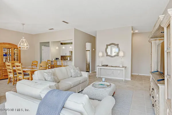 a living room with furniture and a large mirror