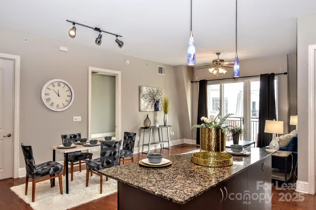 a dining room with furniture and wooden floor
