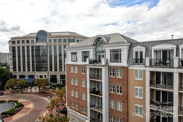 a front view of a residential apartment building with a yard