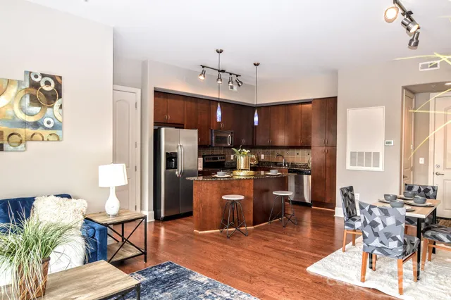 a living room with furniture and wooden floor
