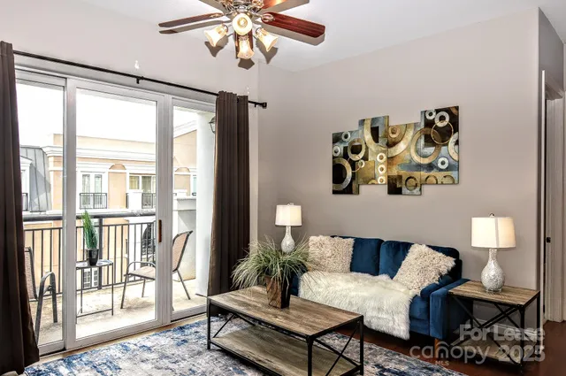 a view of a livingroom with furniture window and wooden floor