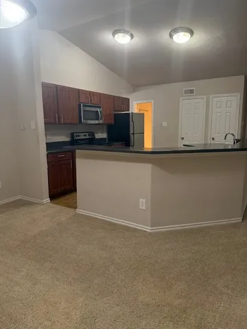 a view of kitchen with microwave and cabinets