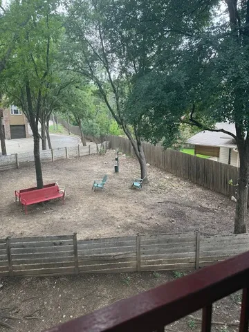 a view of empty room with floor to ceiling window and tree