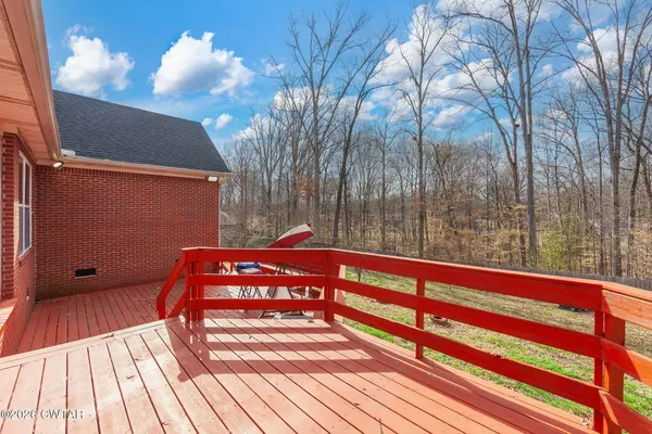 a view of wooden floor and a bench in a yard