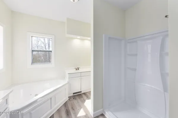 a bathroom with a bathtub and shower