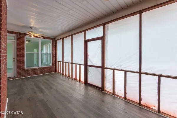 a view of an entryway with wooden floor
