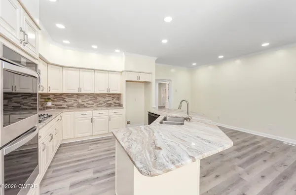 a kitchen with a sink microwave and cabinets