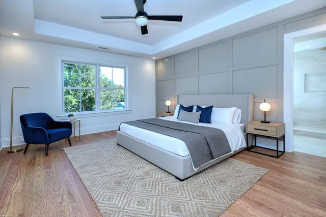 a bedroom with a bed a couch and a potted plant