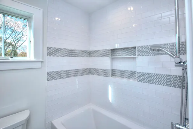 a bathroom with a bathtub and shower