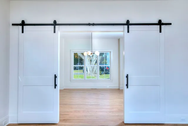 a view of a room with window & refrigerator