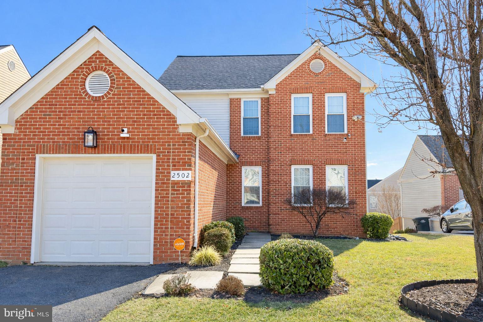 a view of a brick house with a yard