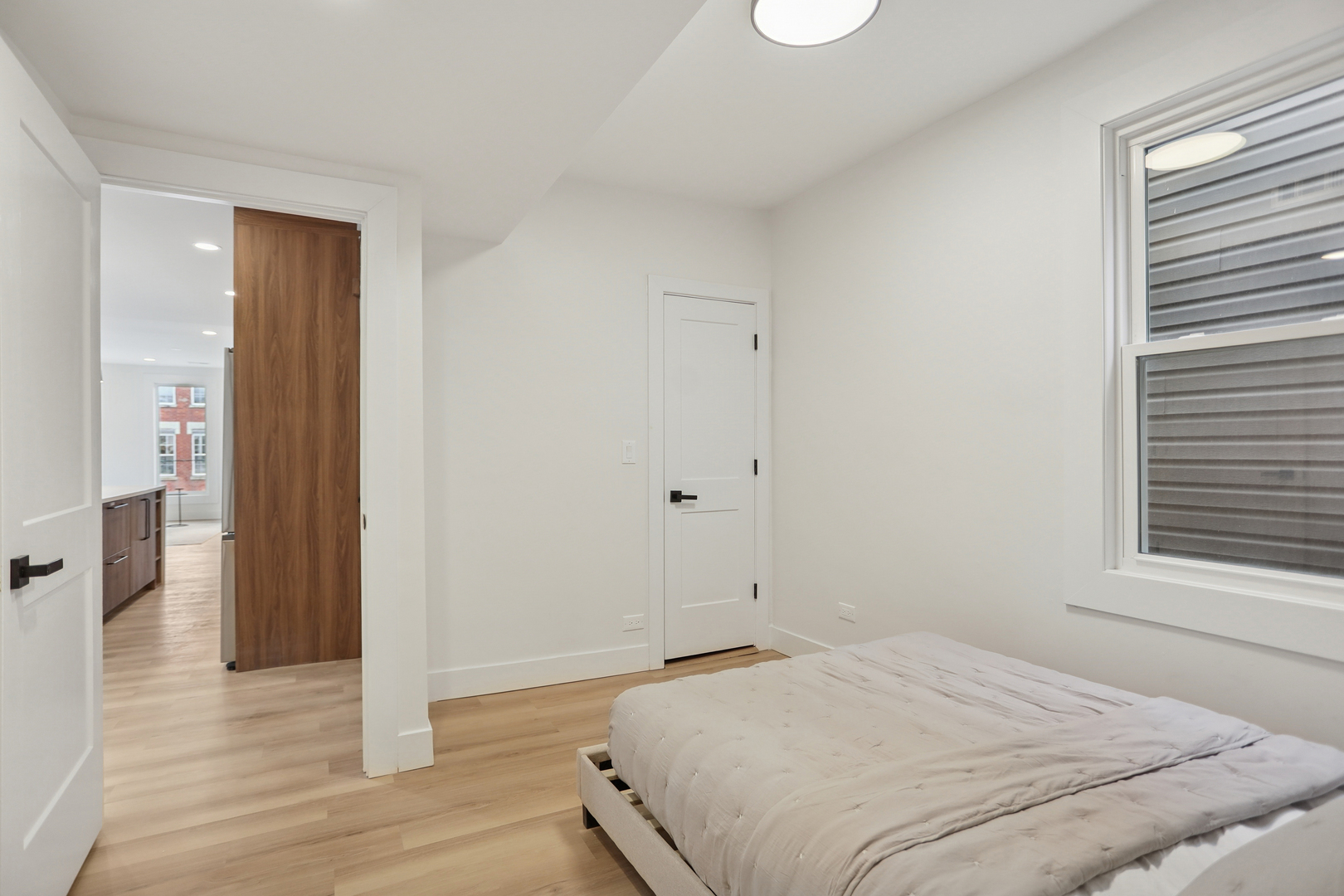 1310 West Erie Street, Unit 2 Chicago, IL 60642 - Photo 11 of 12 a bedroom with a bed and a window