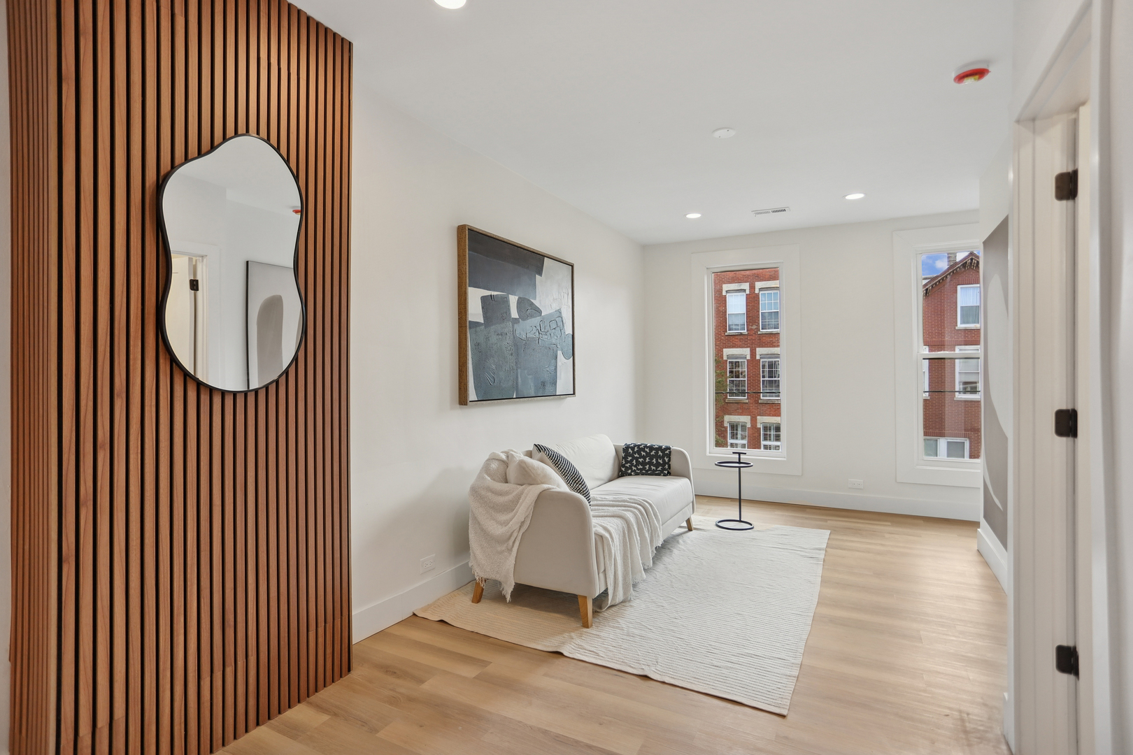 1310 West Erie Street, Unit 2 Chicago, IL 60642 - Photo 5 of 12 a living room with furniture a rug and a window