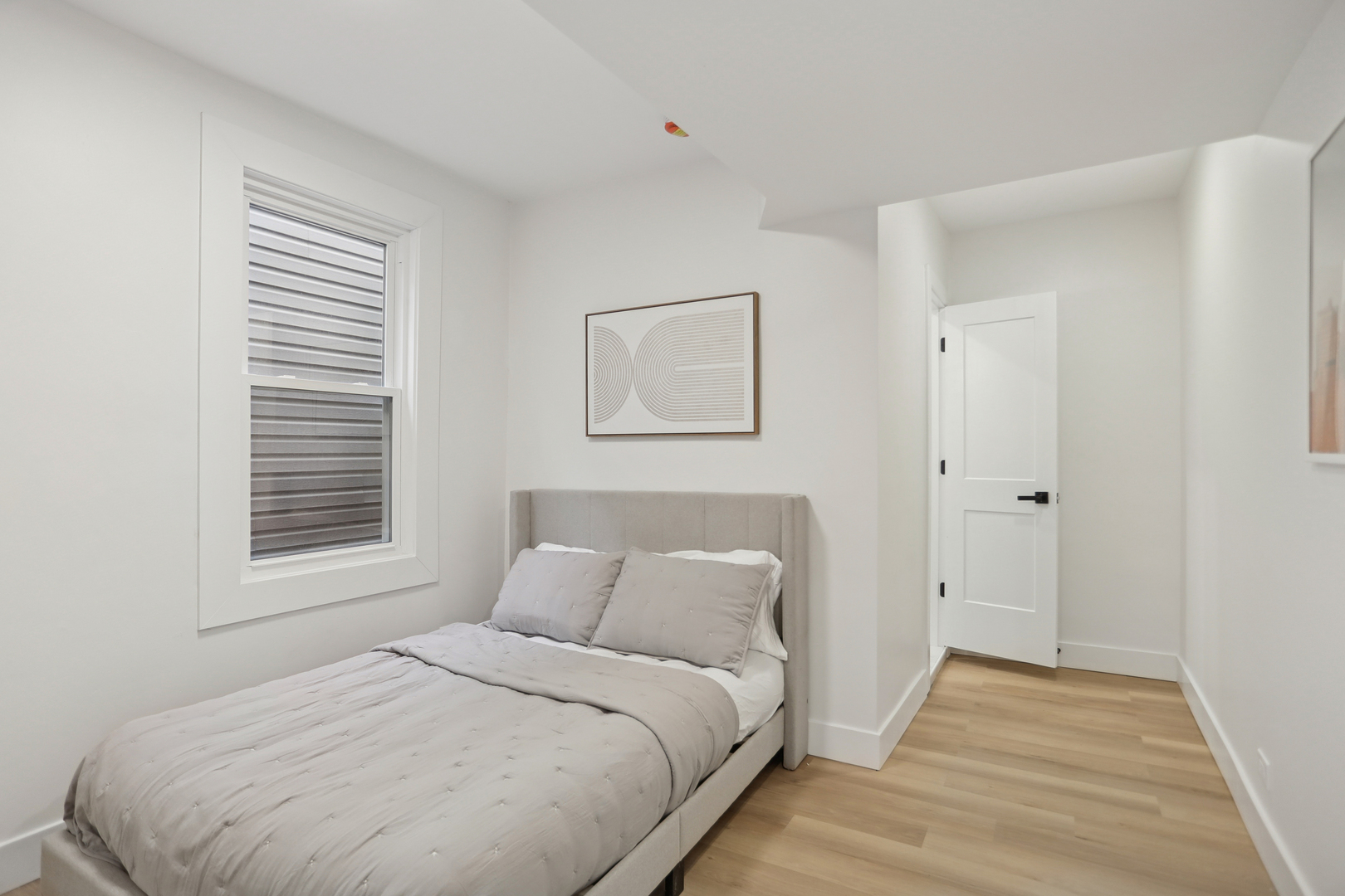 1310 West Erie Street, Unit 2 Chicago, IL 60642 - Photo 9 of 12 a bedroom with a bed and a window