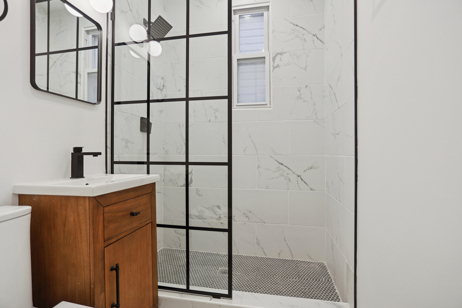 1310 West Erie Street, Unit 2 Chicago, IL 60642 - Photo 10 of 12 a bathroom with a shower and mirror