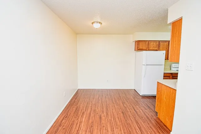 a view of a room with wooden floor and cabinet