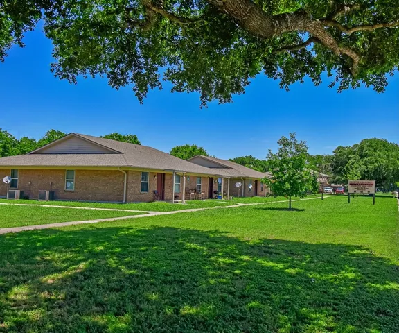 a front view of a house with a yard table and chairs