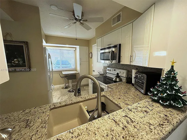 a living room with furniture flowerpot and a rug
