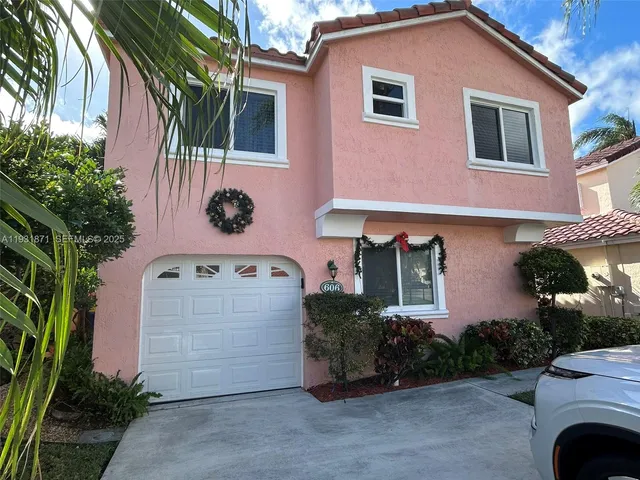 a view of a house with patio and a garden