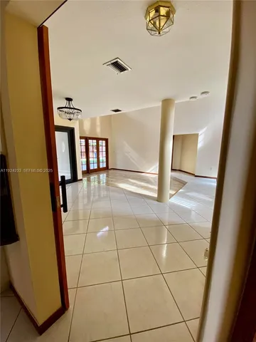 a view of a livingroom with an empty space and a window