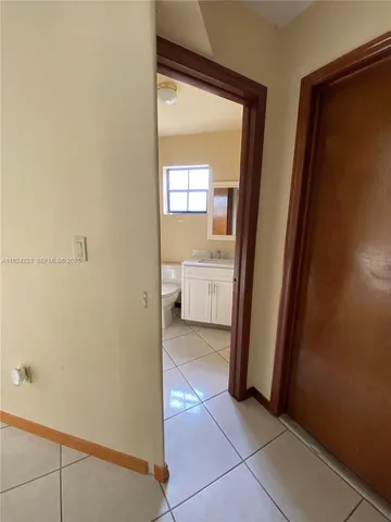 a view of a bathroom from a corridor