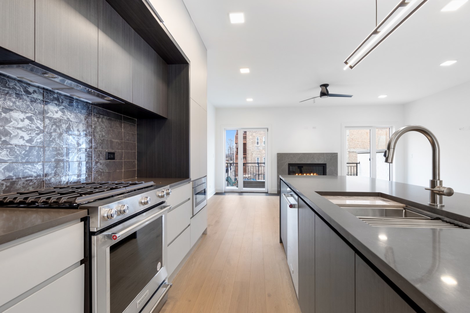 334 East Pershing Road Chicago, IL 60653 - Photo 17 of 86 a kitchen with stainless steel appliances granite countertop a sink stove and cabinets
