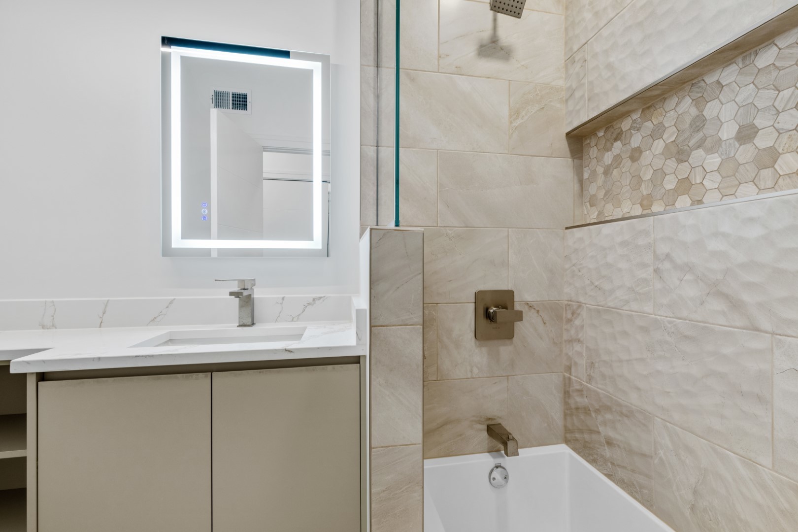 334 East Pershing Road Chicago, IL 60653 - Photo 58 of 86 a bathroom with a granite countertop sink a mirror and a bathtub