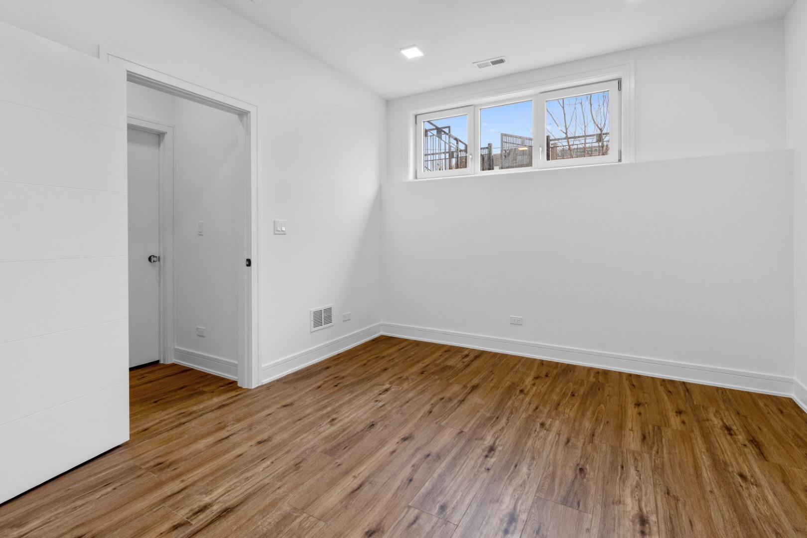 334 East Pershing Road Chicago, IL 60653 - Photo 64 of 86 a view of an empty room with wooden floor