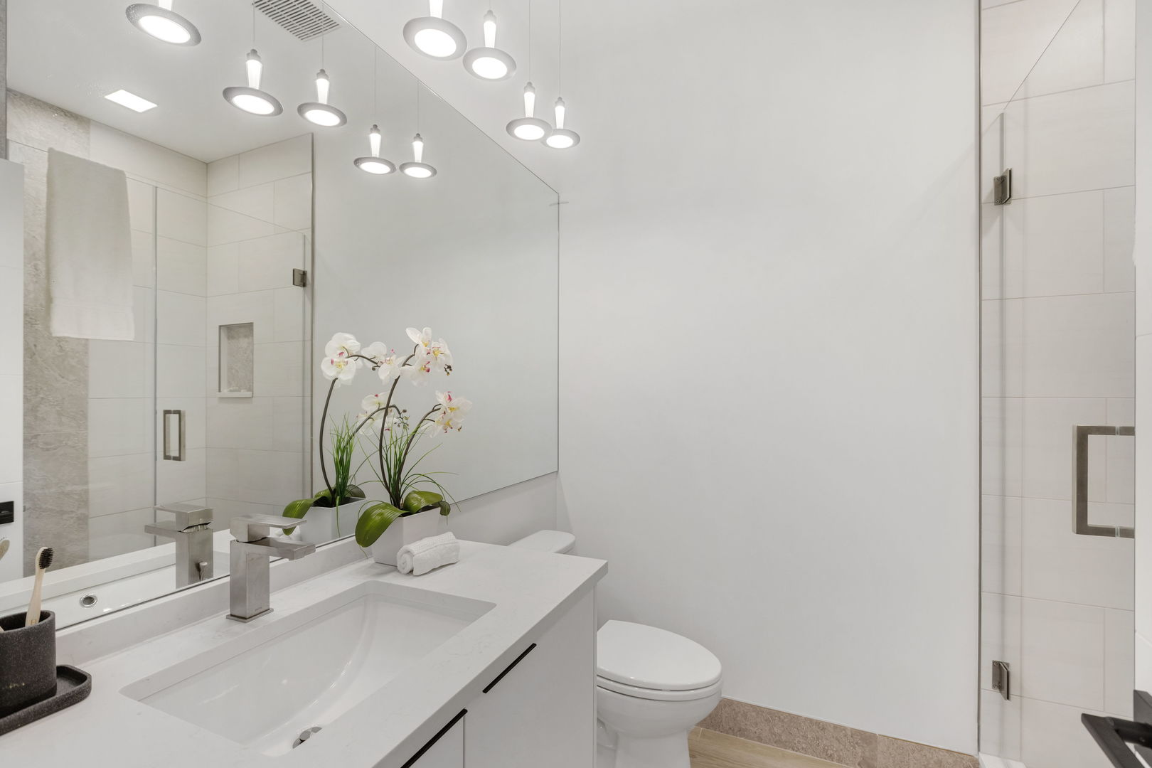 334 East Pershing Road Chicago, IL 60653 - Photo 65 of 86 a bathroom with a granite countertop sink a toilet and a mirror