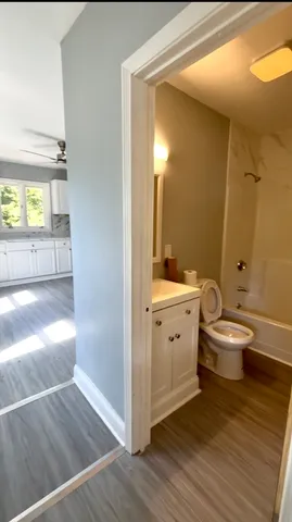 a bathroom with a double vanity sink toilet and a mirror