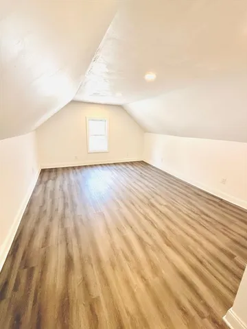 a view of wooden floor and brick wall