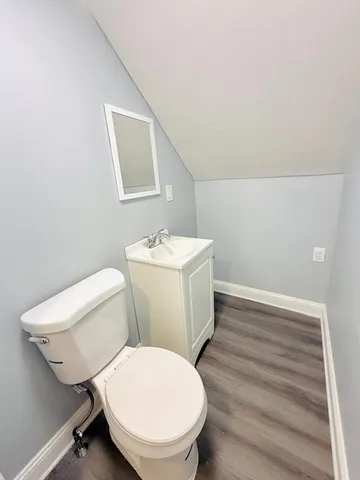 a white toilet sitting next to a bathroom sink