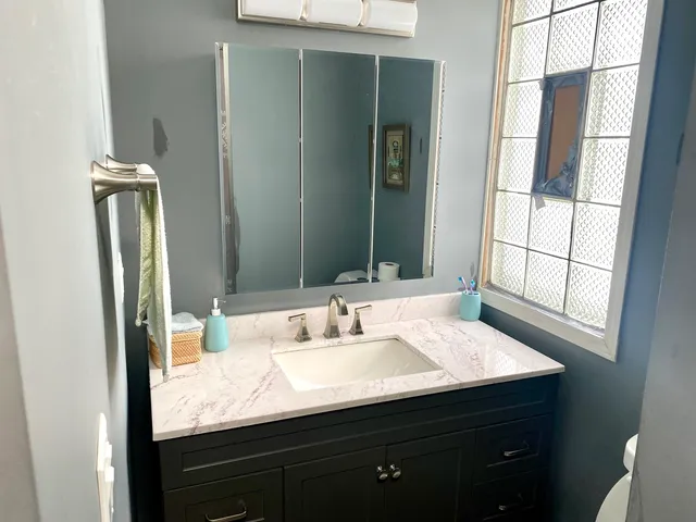 a bathroom with a sink and a mirror
