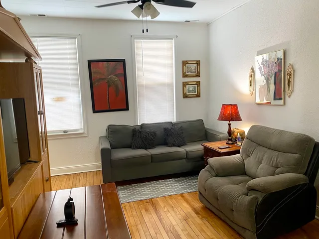 a living room with furniture and a flat screen tv