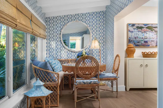 a kitchen with stainless steel appliances kitchen island granite countertop a table chairs sink and cabinets