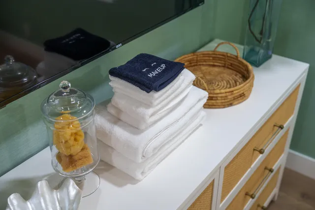 a bathroom with a granite countertop sink a toilet and shower