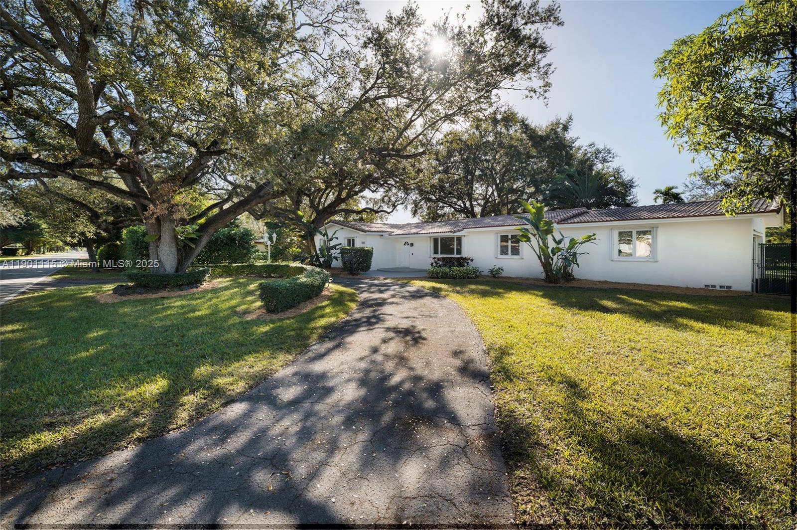 8390 Southwest 132nd Street Pinecrest, FL 33156 - Photo 1 of 12 a view of a house with a big yard