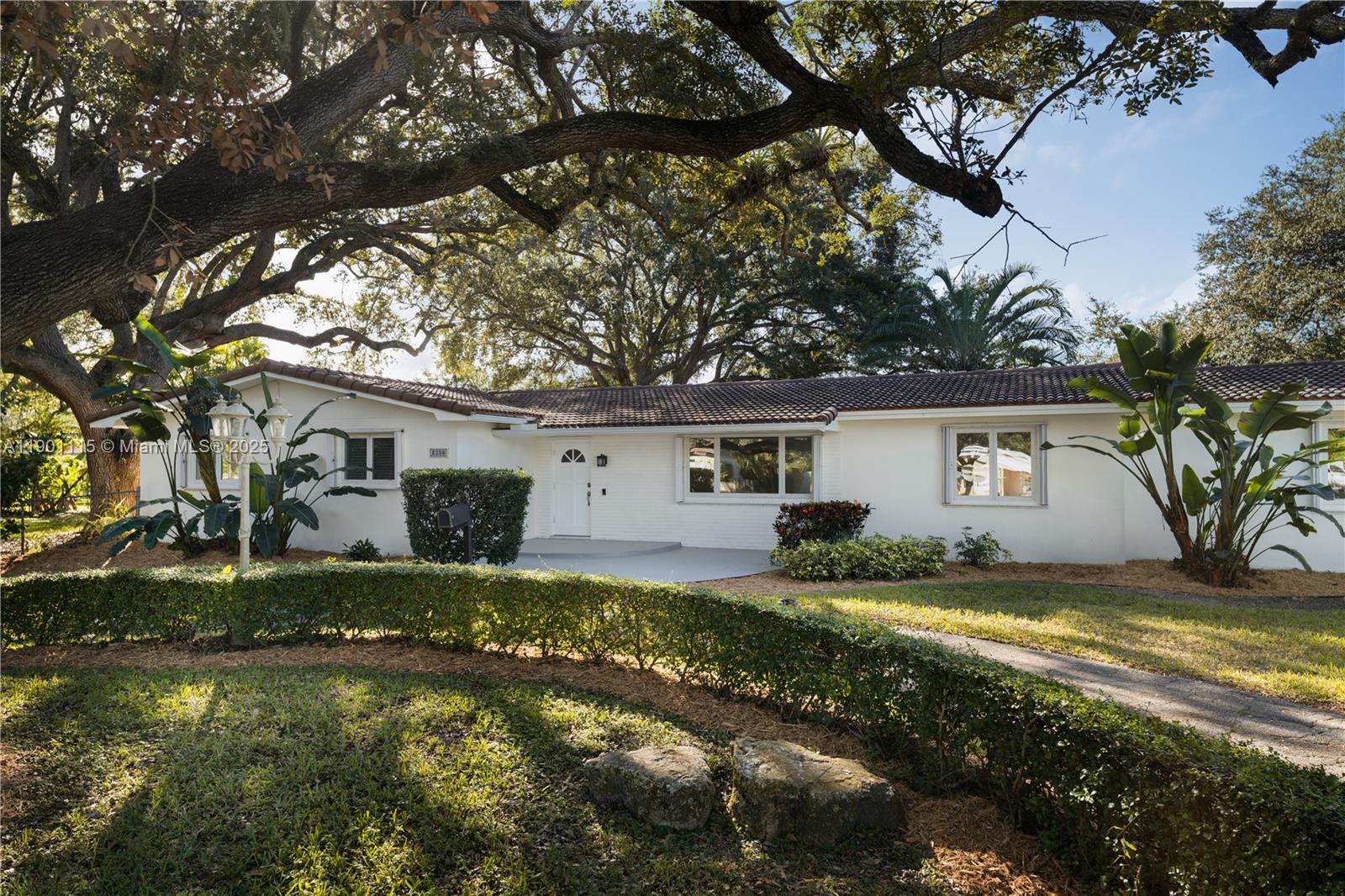 8390 Southwest 132nd Street Pinecrest, FL 33156 - Photo 2 of 12 a view of a house with a big yard