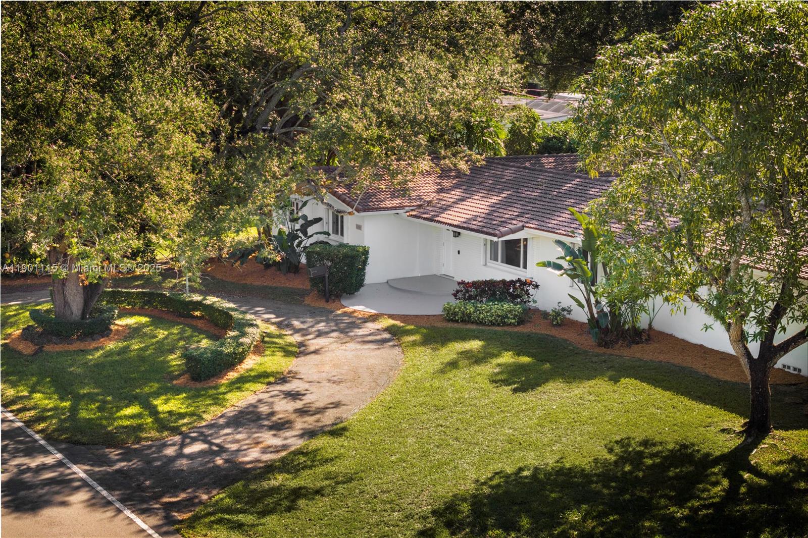 8390 Southwest 132nd Street Pinecrest, FL 33156 - Photo 4 of 12 a view of a house with a yard