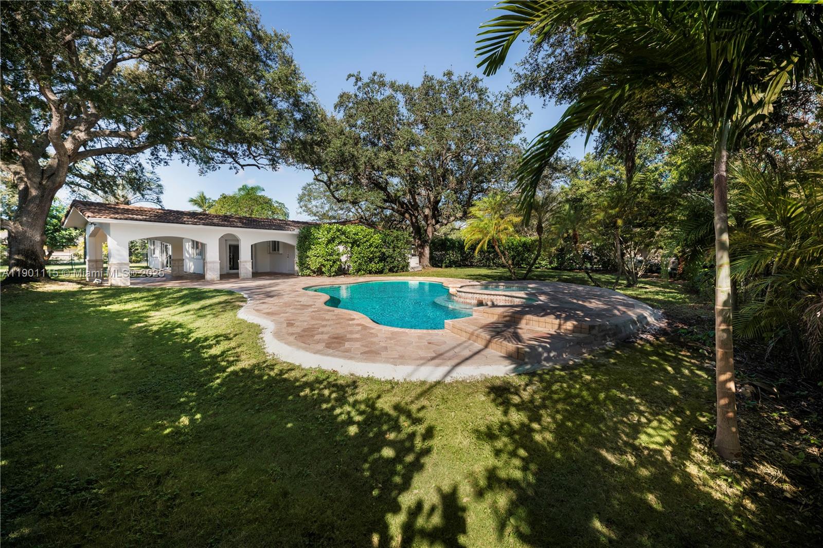 8390 Southwest 132nd Street Pinecrest, FL 33156 - Photo 5 of 12 a view of a house with a yard