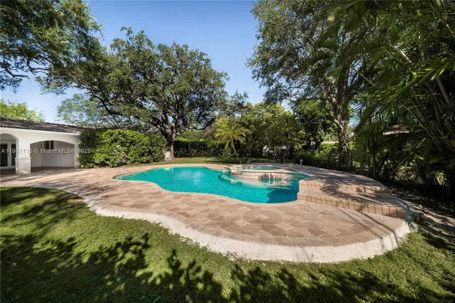 a view of a swimming pool with a yard
