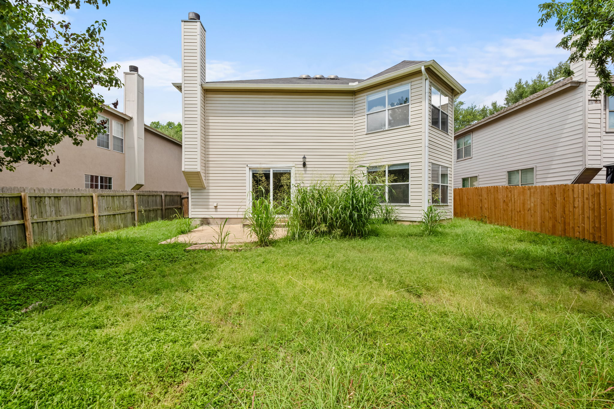 1408 Water Spaniel Way Round Rock, TX 78664 - Photo 31 of 37 A spacious backyard with mature trees provides ample room for outdoor activities.