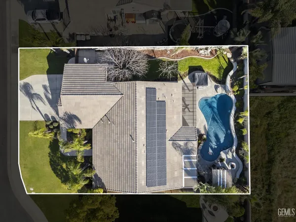 an aerial view of a house with a swimming pool
